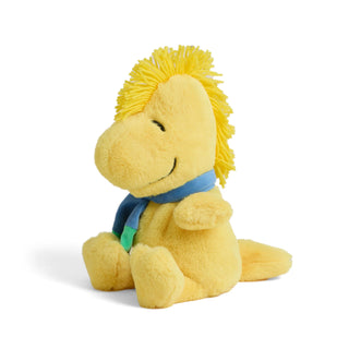 Warmies Woodstock plush toy wearing a blue winter scarf, sitting upright with soft yellow fur and cheerful embroidered smile.