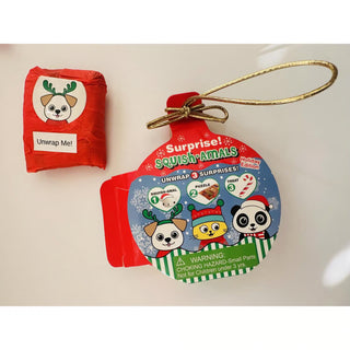 Close-up of Zorbitz Squish Amal Holiday Ornament featuring three surprises: Squish-amal toy, holiday puzzle, and wrapped treat.