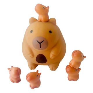 Squishy capybara toy with five mini baby capybaras stacked and displayed, squishable collectible surprise toy set.