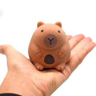 Mini squishy capybara toy shown in the palm of a hand for scale, adorable soft collectible stress-relief toy for kids and adults.