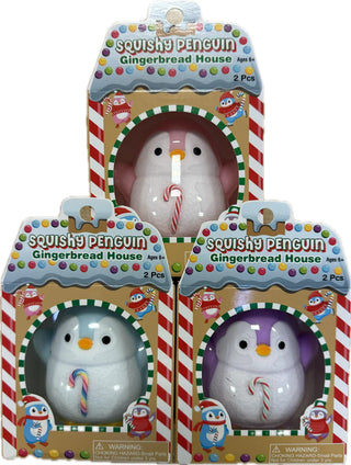 Set of three Squishy Penguin toys in blue, pink, and purple with candy canes, packaged in gingerbread house boxes.