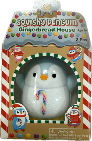 Blue penguin squishy toy with rainbow candy cane in gingerbread house packaging, holiday collectible gift.