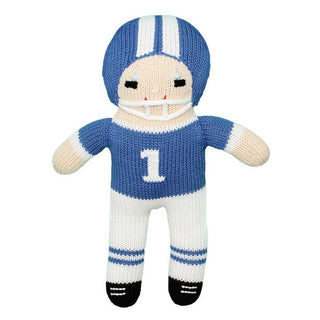 Knitted football player doll in blue and white uniform on a white background