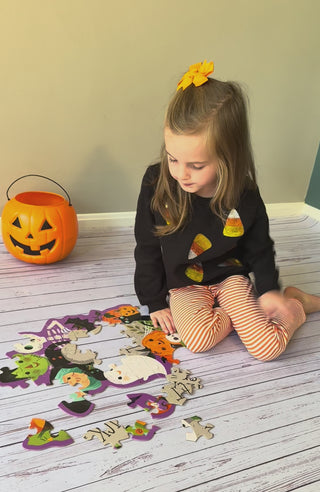 Mud Pie candy corn sequin sweatshirt with orange striped leggings set, video of young girl working on a puzzle in this Halloween outfit.