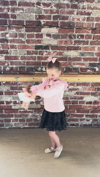 Mud Pie ballerina doll with pink and pastel tutu, young girl twirling in a dance studio holding this soft plush ballerina toy.